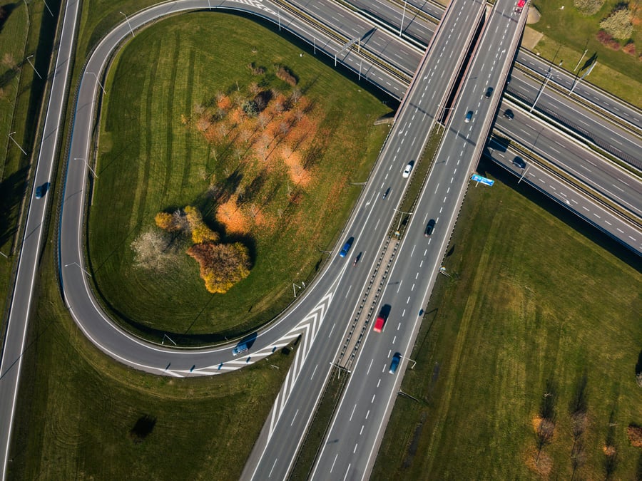 An aerial view of a motorway junction with several vehicles in motion