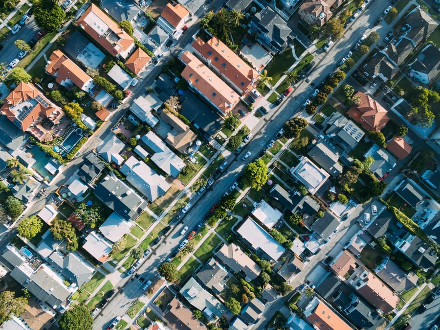 An aerial views of a road cutting diagonally through suburbs